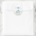 Watercolor Coastal New England Wedding Thank You Runt Klistermärke<br><div class="desc">This elegant watercolor wedding thank you sticker captures the serene beauty of a New England beach wedding. Featuring a hand-painted lighthouse overlooking soft dunes and gentle ocean waves, the design sets a romantic coastal tone. The layout strikes a balance between timeless charm and seaside whimsy. Ideal as envelope seals or...</div>