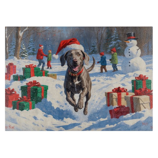 Weimaraner springer i snö med julhatt (Framsidan)