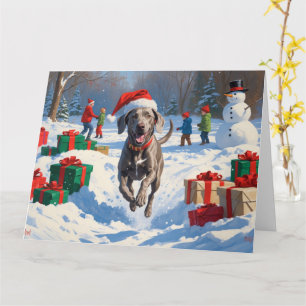 Weimaraner springer i snö med julhatt kort