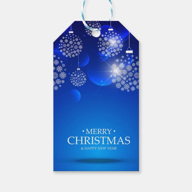 White Bollar Presentetikett (A Christmas tag with a blue background and white snowflakes. )