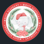 White Elephant-jul Runt Klistermärke<br><div class="desc">Den här söta vita elefantdekalen har en vattenfärgselefant som håller på att ta sig ut från en julkrans. "vit elefant" i ord är skriven i vitt runt kant på röd bakgrund.</div>