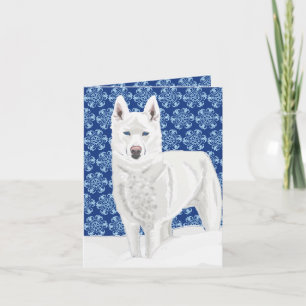 White Husky mot Snö Flakes och mörk blått himlar Kort