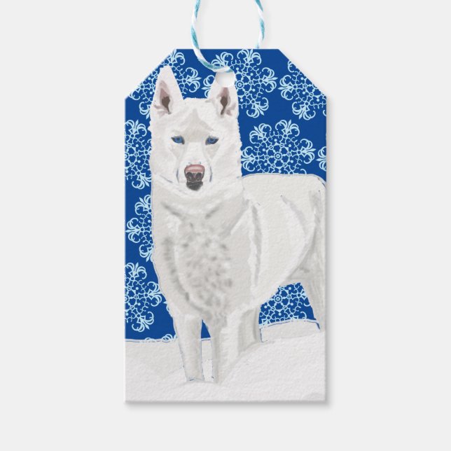 White Husky mot Snö Flakes och mörk blått himlar. Presentetikett (Framsidan)