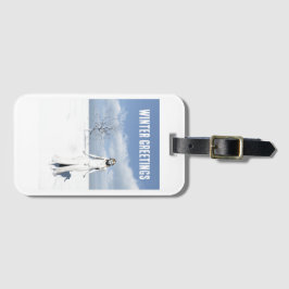 Winter Greetings. Female elf walking in the snow  Bagagebricka