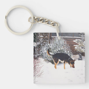 Winter snö scen med söt svart och brunt hund