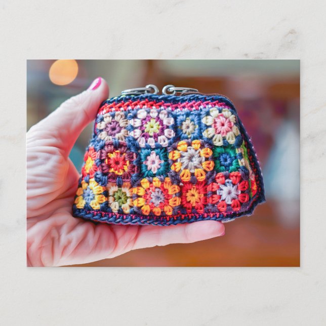 Woman Holding a Crocheted Coin Purse Made From Gra Vykort (Framsida)