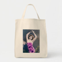woman in purple sarong , arms raised as if dancing
