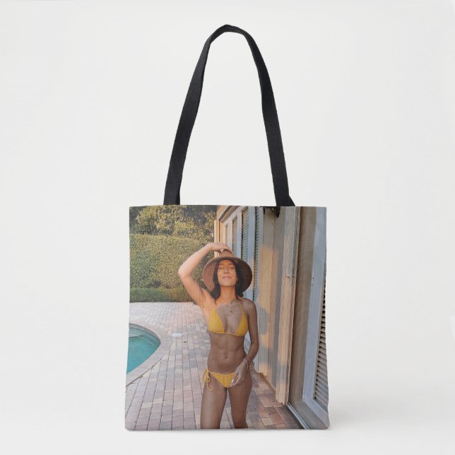Woman in yellow bikini standing on brown brick flo tygkasse (Framsida)
