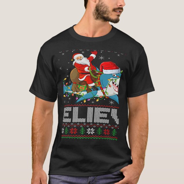 Xmas Lights Shark Believe Ugly Santa Riding Shark  T Shirt (Framsida)