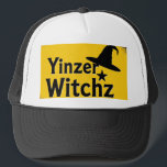 YinzerWitchz Keps<br><div class="desc">This quirky trucker style hat features a whimsical spray paint inspired print in black and yellow with the bold words Yinzer Witchz.</div>