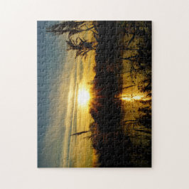 Zonsondergang bij een meertje met rietpluimen. pussel